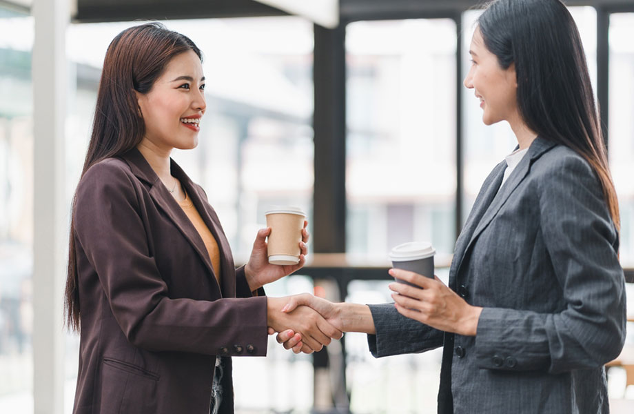 two businesswomen meeting for coffee 