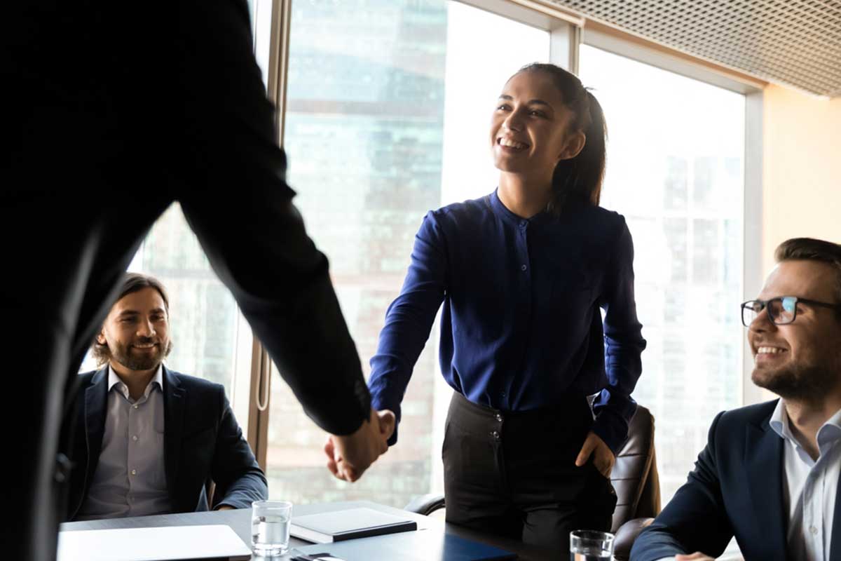 business woman shaking hands to make a good first impression at a business networking event in Hertfordshire